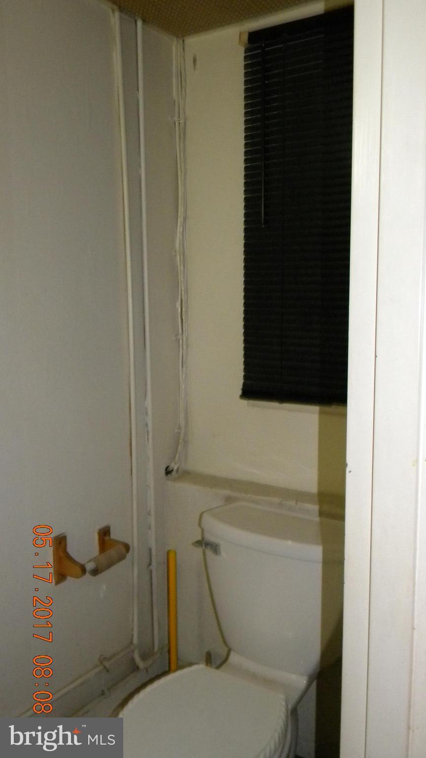 917 Prestwood Road Baltimore, MD 21228 - Photo 9 of 18 a bathroom with a granite countertop toilet and a sink