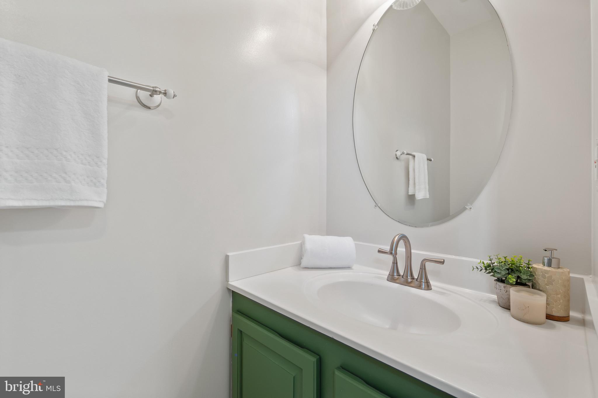 1242 Weatherstone Court Reston, VA 20194 - Photo 14 of 40 a bathroom with a sink and a mirror