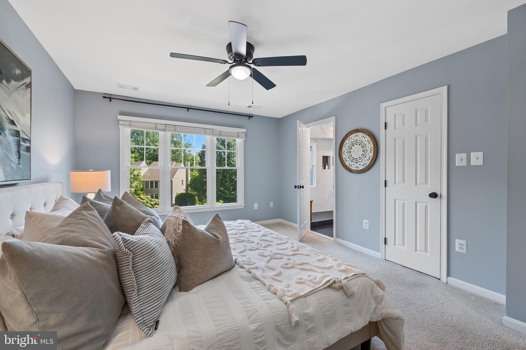 1242 Weatherstone Court Reston, VA 20194 - Photo 17 of 40 a bedroom with a large bed and a window