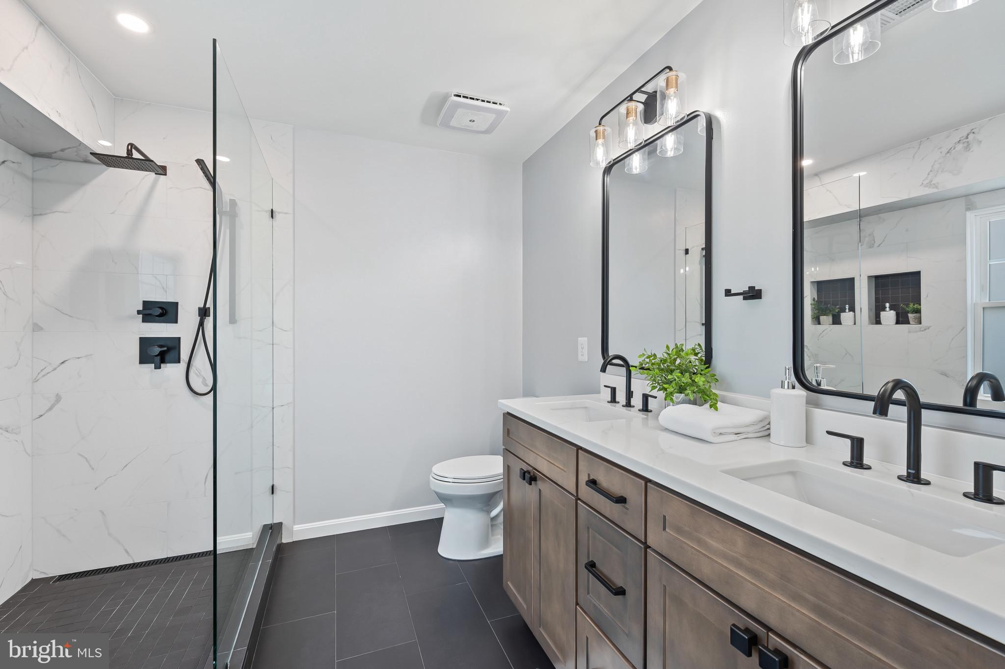 1242 Weatherstone Court Reston, VA 20194 - Photo 21 of 40 a bathroom with a double vanity sink toilet and shower