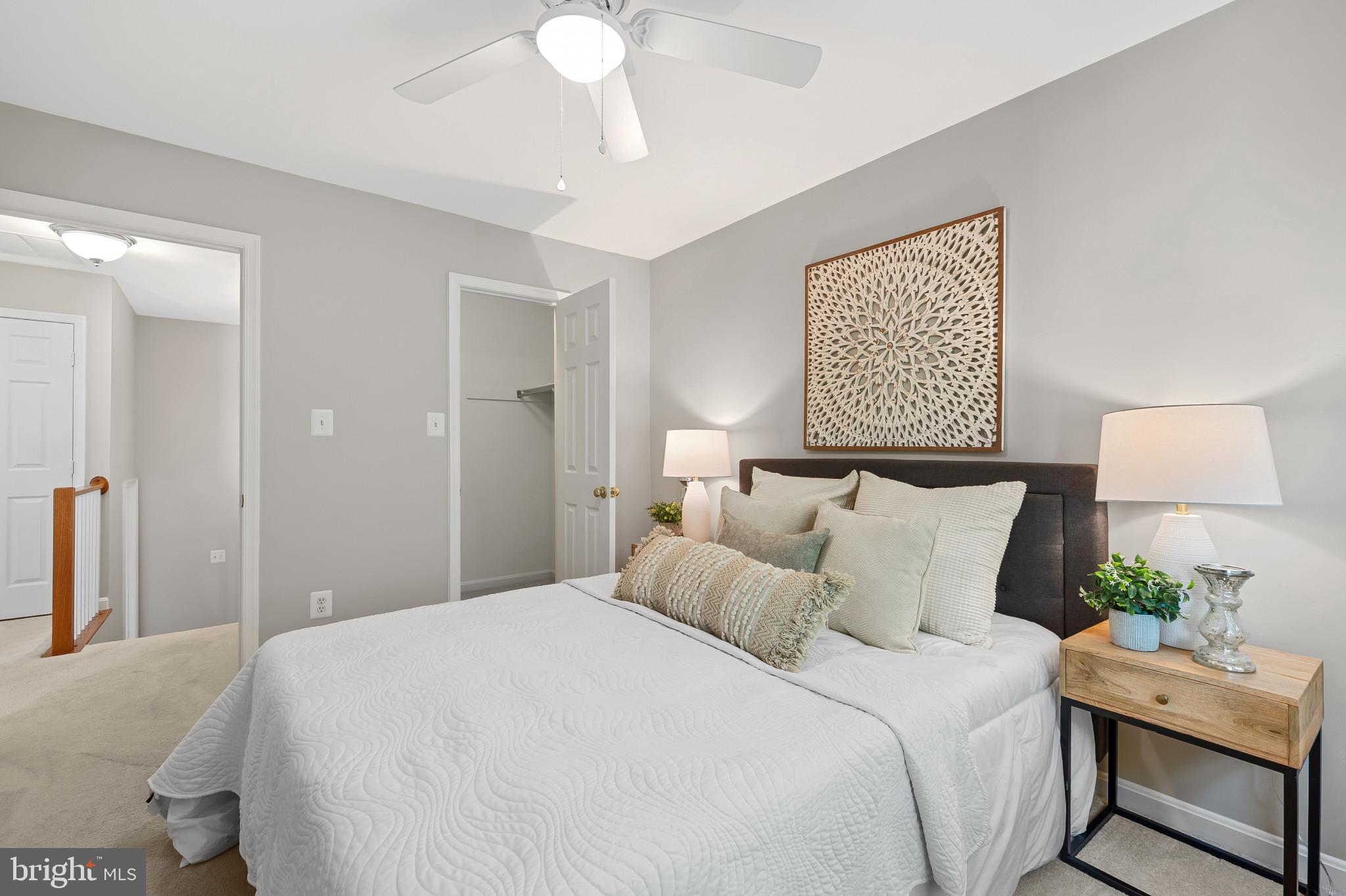 1242 Weatherstone Court Reston, VA 20194 - Photo 24 of 40 a bedroom with a bed and a lamp