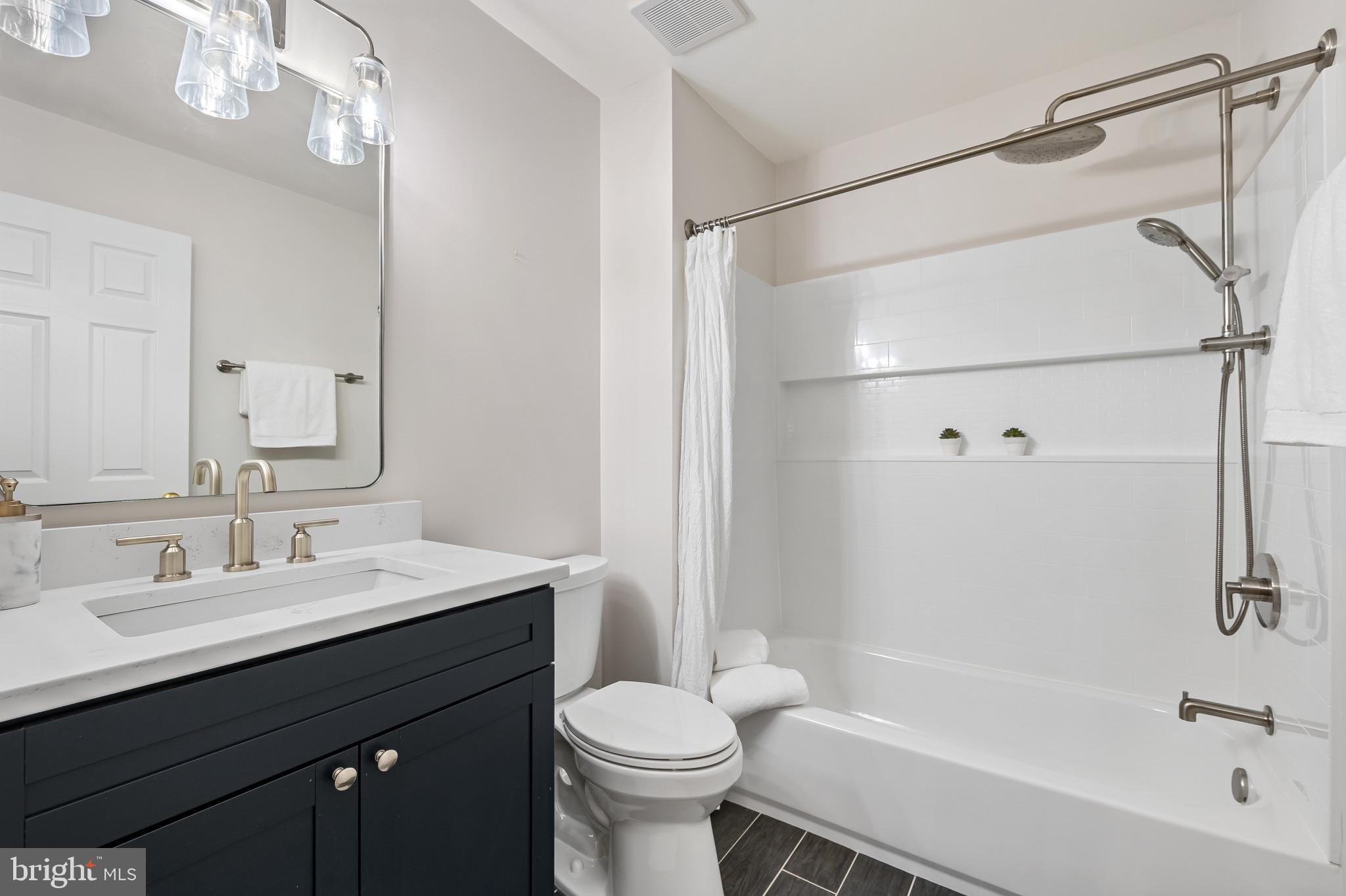 1242 Weatherstone Court Reston, VA 20194 - Photo 28 of 40 a bathroom with a sink a toilet and shower