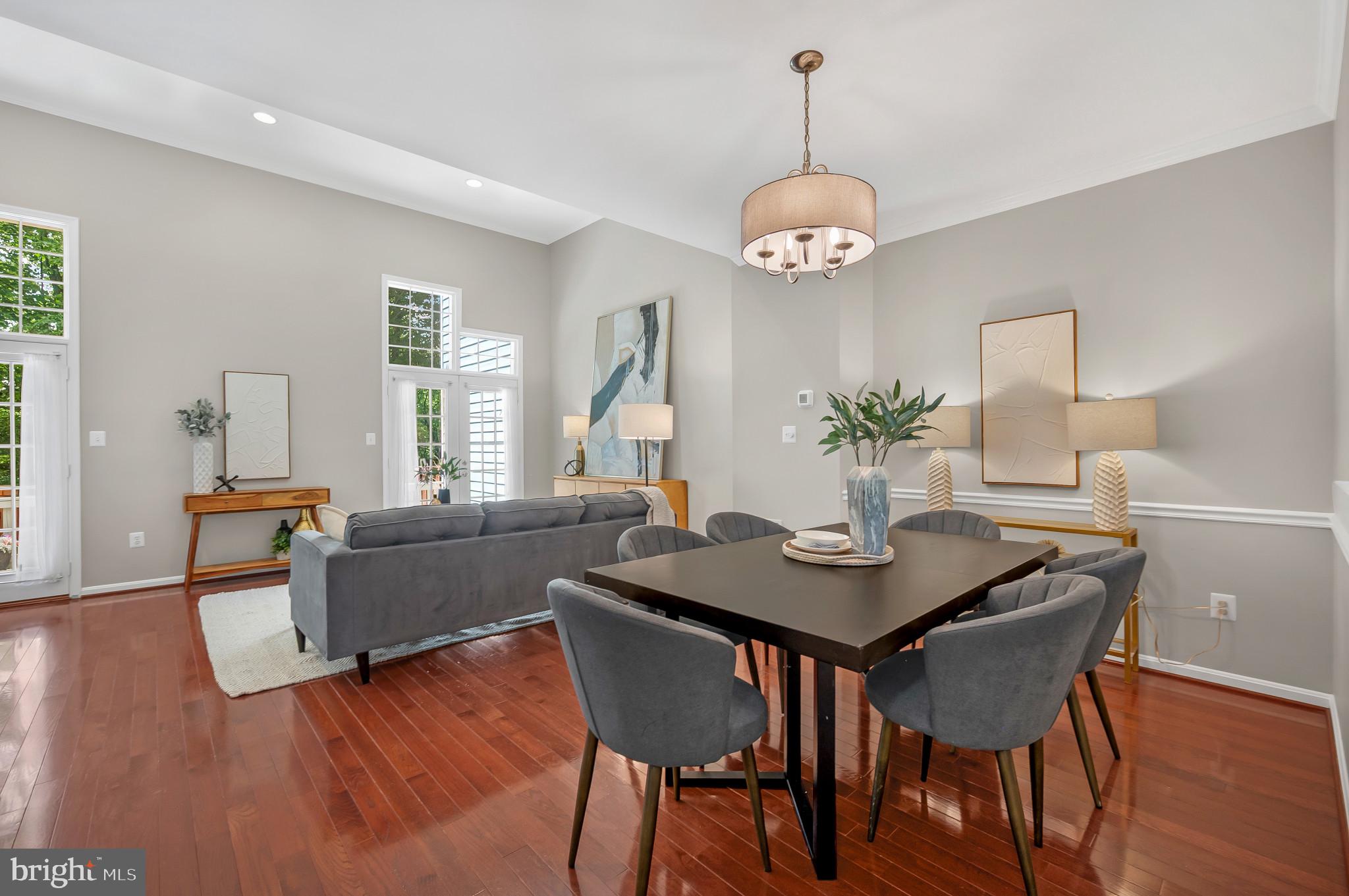 1242 Weatherstone Court Reston, VA 20194 - Photo 3 of 40 a view of a dining room with furniture wooden floor and chandelier