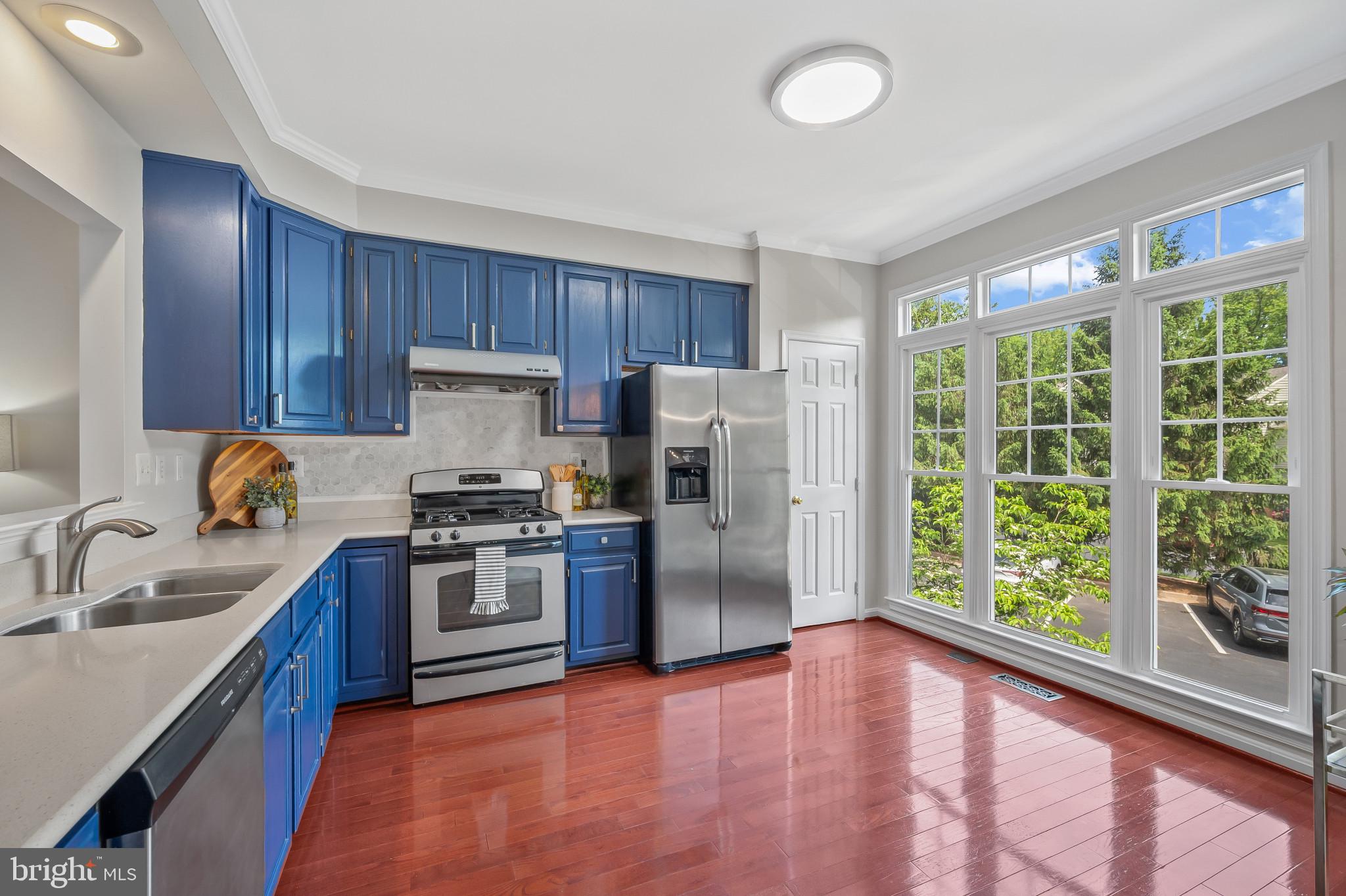 1242 Weatherstone Court Reston, VA 20194 - Photo 6 of 40 a kitchen with a sink a stove a refrigerator cabinets and a window