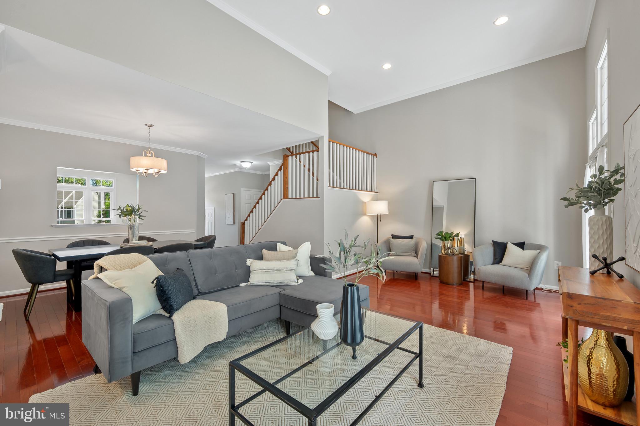 1242 Weatherstone Court Reston, VA 20194 - Photo 10 of 40 a living room with furniture a rug and a chandelier