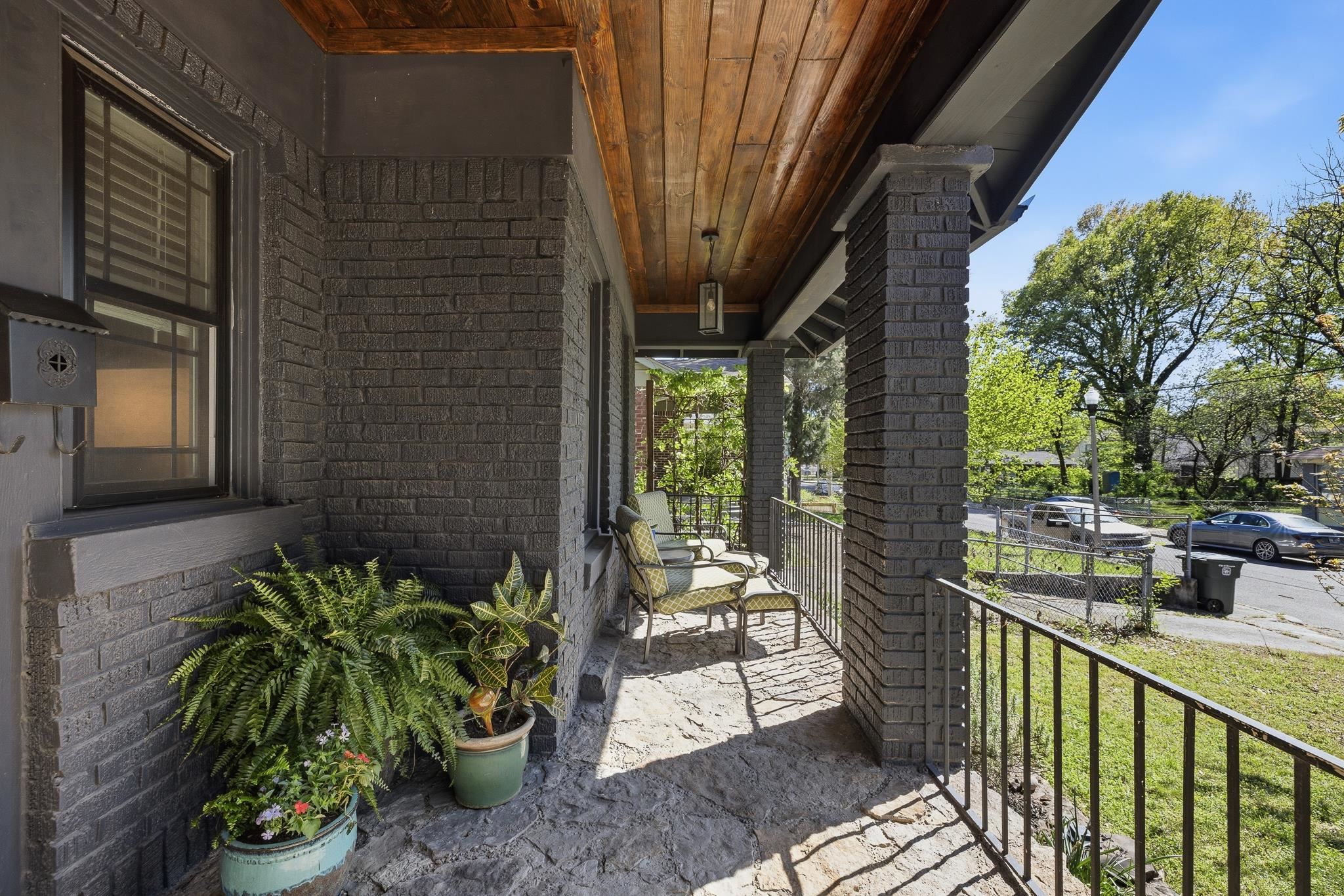 1044 Bruce Street Memphis, TN 38104 - Photo 3 of 34 a porch with chairs and potted plants