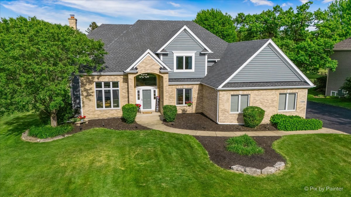 7104 Dove Way Cary, IL 60013 - Photo 1 of 82 a front view of a house with a yard and garage