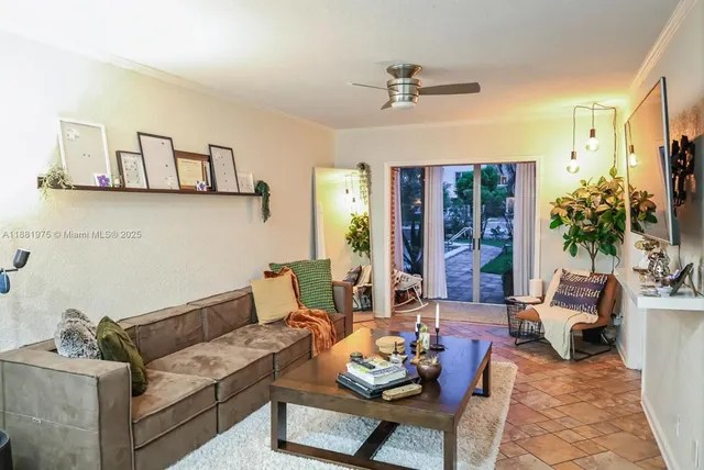 a living room with furniture kitchen view and large window