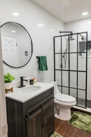 a bathroom with a sink mirror and toilet