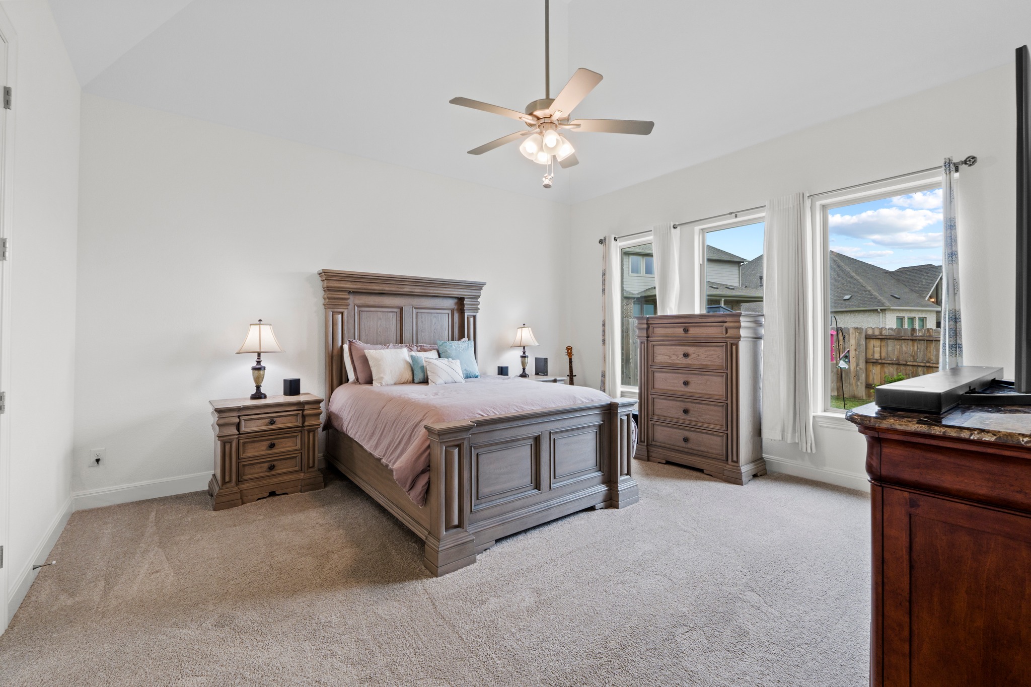 271 Tubman Drive Kyle, TX 78640 - Photo 12 of 40 a spacious bedroom with a bed and a chandelier