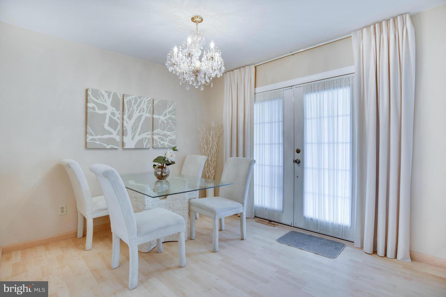 256 Magothy Bridge Road Pasadena, MD 21122 - Photo 11 of 24 a dining room with furniture a chandelier and wooden floor