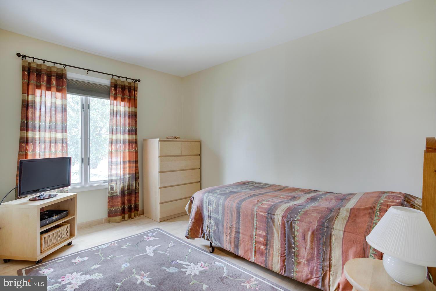 256 Magothy Bridge Road Pasadena, MD 21122 - Photo 13 of 24 a bedroom with a bed and a television