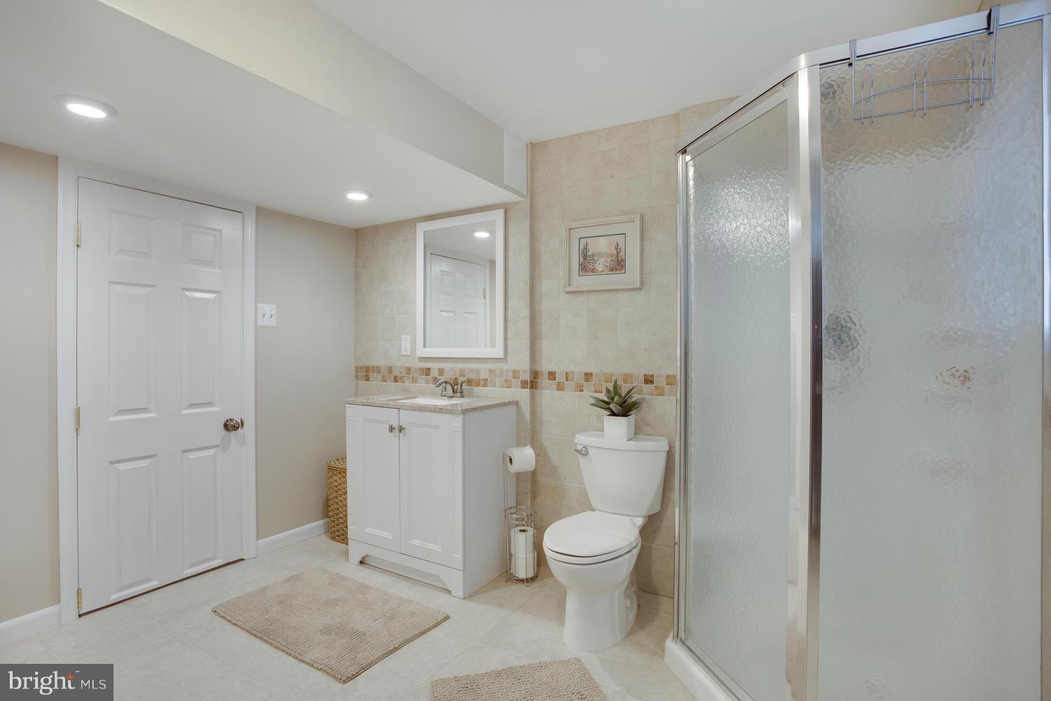256 Magothy Bridge Road Pasadena, MD 21122 - Photo 19 of 24 a bathroom with a toilet sink and shower