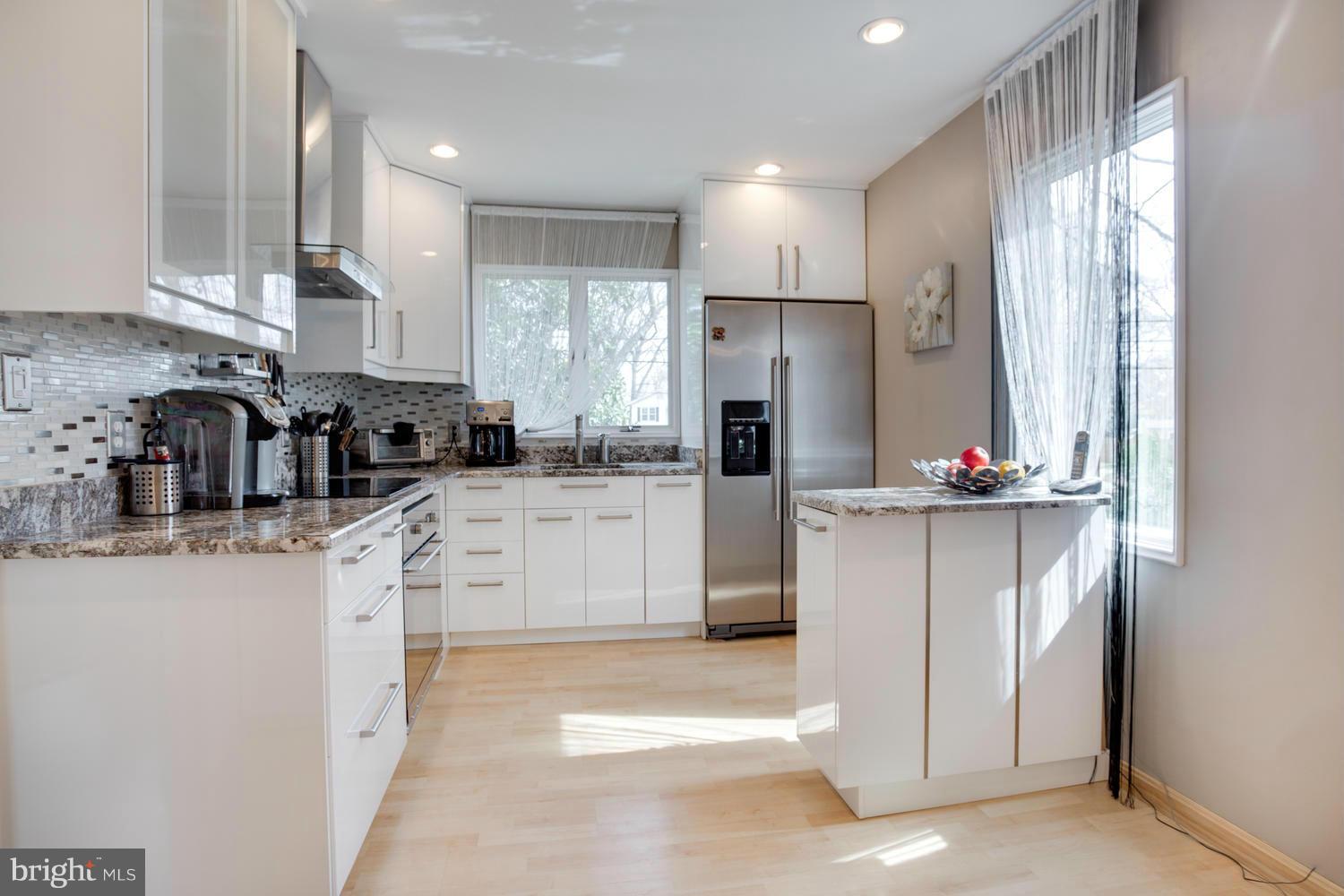 256 Magothy Bridge Road Pasadena, MD 21122 - Photo 4 of 24 a kitchen with refrigerator and cabinets