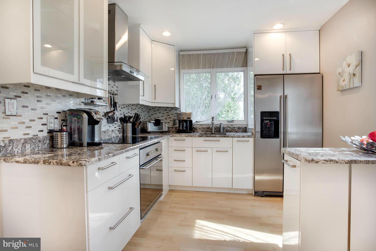 256 Magothy Bridge Road Pasadena, MD 21122 - Photo 5 of 24 a kitchen with stainless steel appliances kitchen island granite countertop a refrigerator sink and cabinets