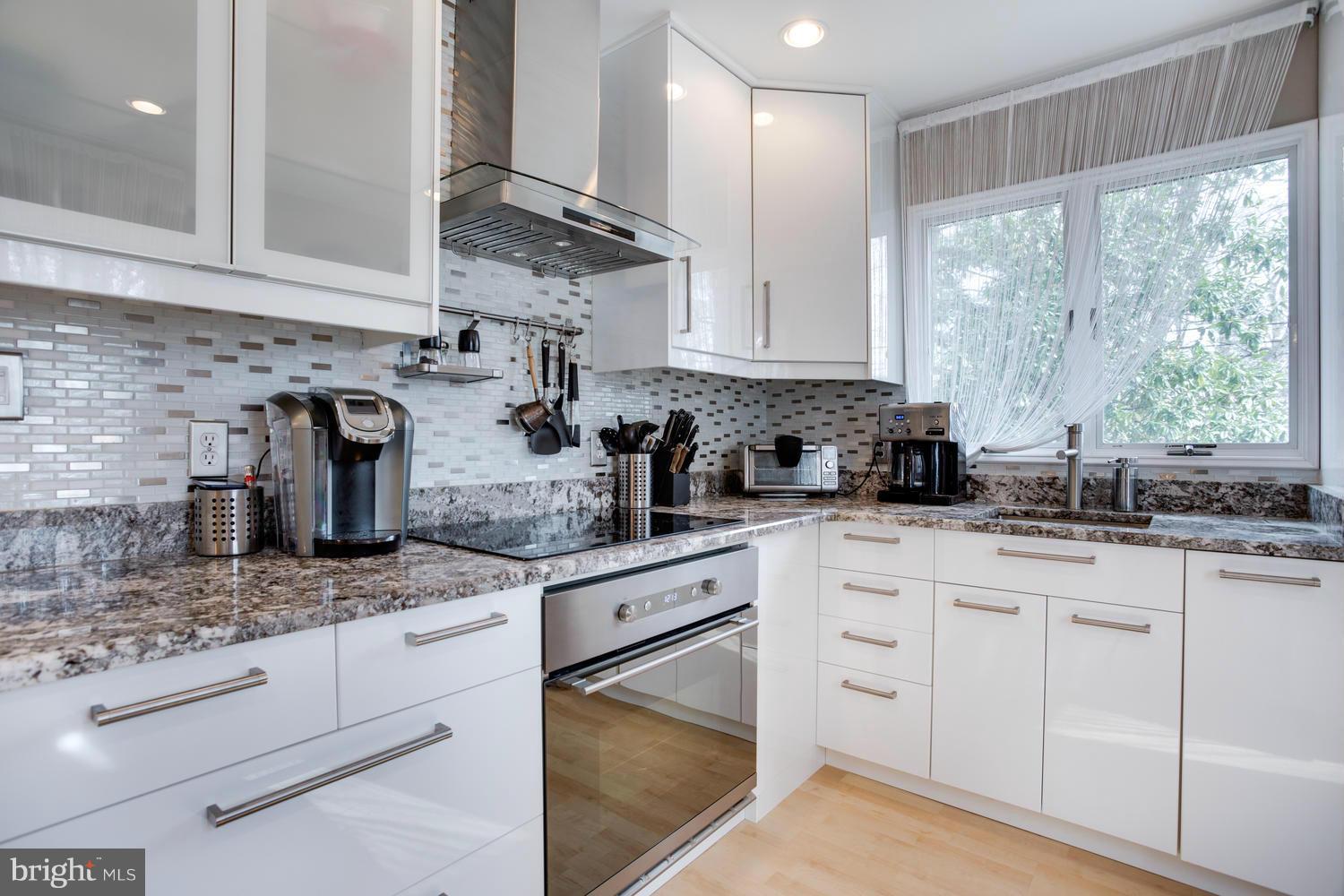 256 Magothy Bridge Road Pasadena, MD 21122 - Photo 6 of 24 a kitchen with white cabinets and a window