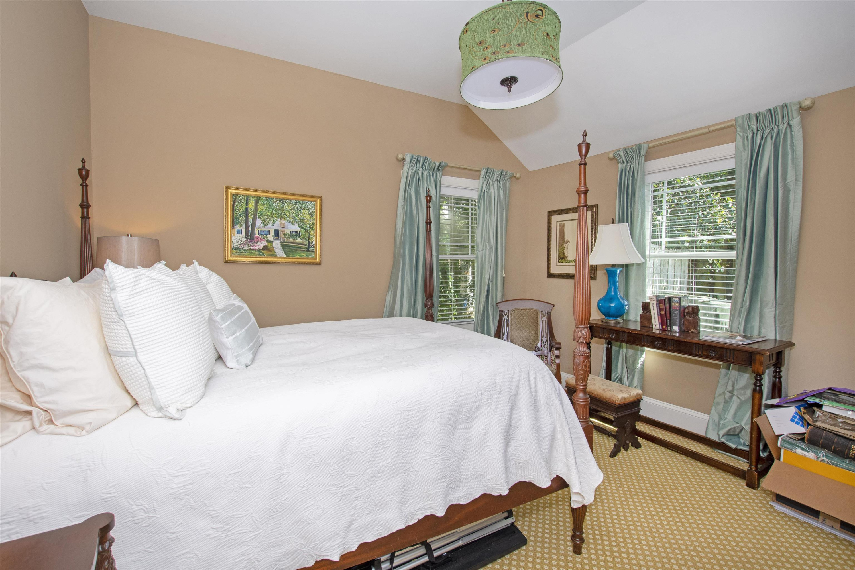 2610 Dover Road Raleigh, NC 27608 - Photo 11 of 20 a bedroom with a bed and a chandelier