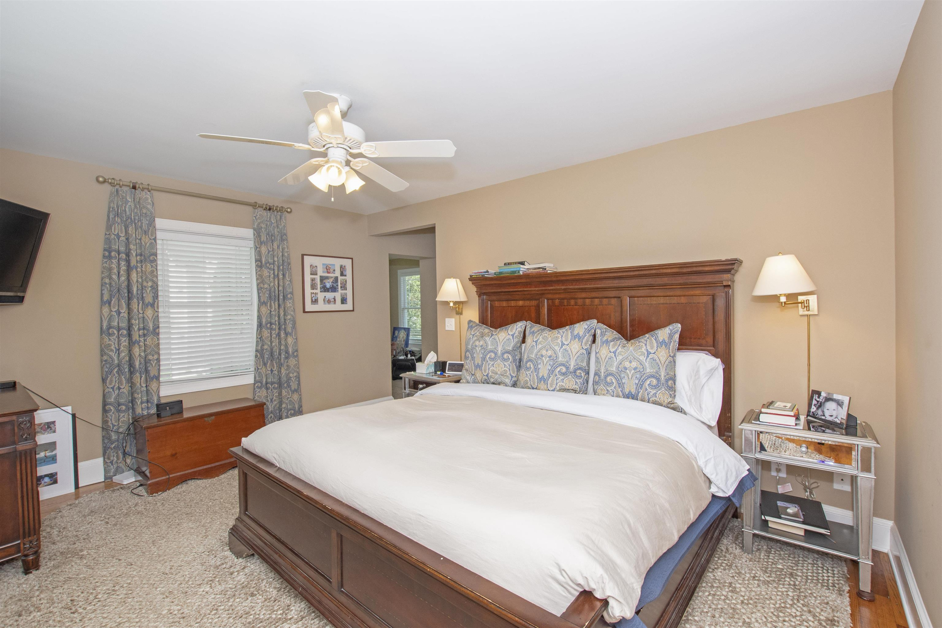 2610 Dover Road Raleigh, NC 27608 - Photo 16 of 20 a bedroom with a bed and a chandelier