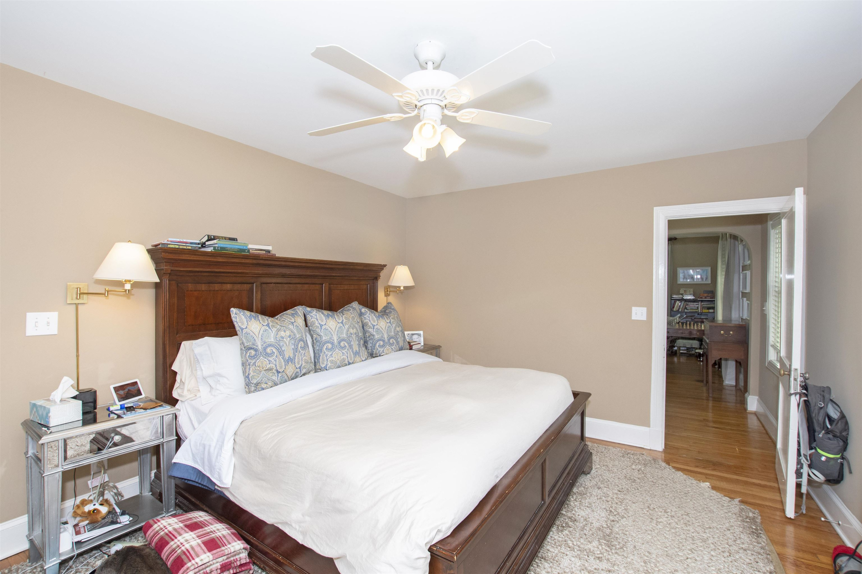 2610 Dover Road Raleigh, NC 27608 - Photo 17 of 20 a bedroom with a bed and a chandelier