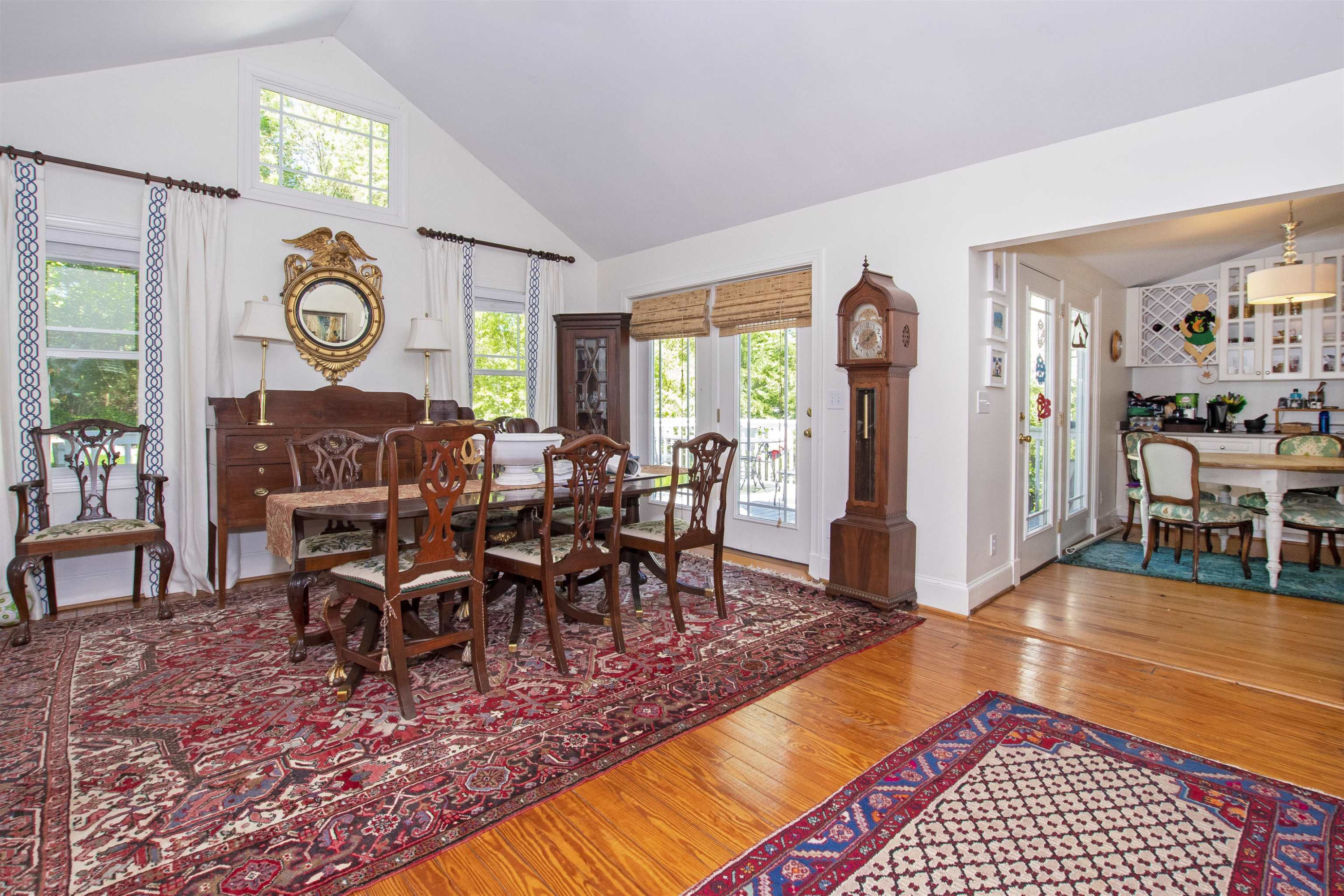 2610 Dover Road Raleigh, NC 27608 - Photo 6 of 20 a view of a dining room and livingroom with furniture wooden floor a rug and a clock