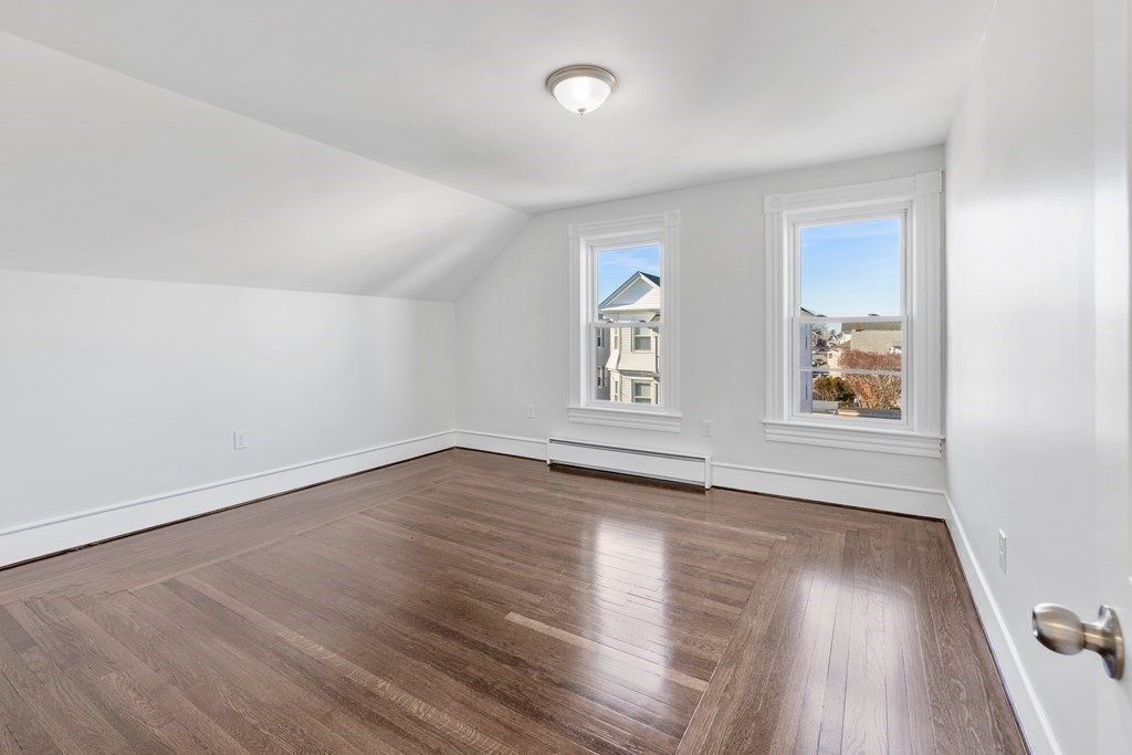 42 Mott Street Fall River, MA 02721 - Photo 14 of 36 an empty room with wooden floor and windows