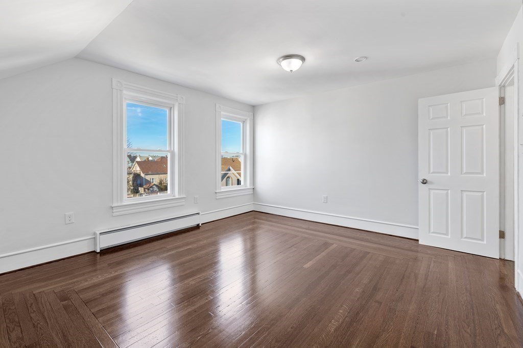 42 Mott Street Fall River, MA 02721 - Photo 18 of 36 an empty room with wooden floor and windows