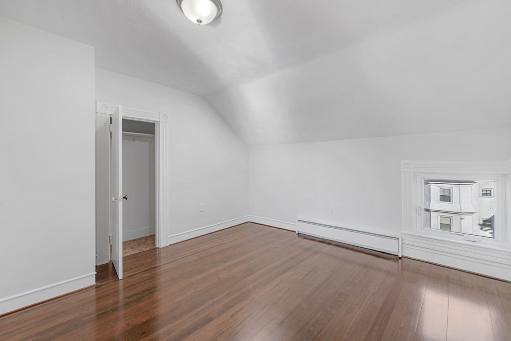 42 Mott Street Fall River, MA 02721 - Photo 20 of 36 an empty room with wooden floor and windows