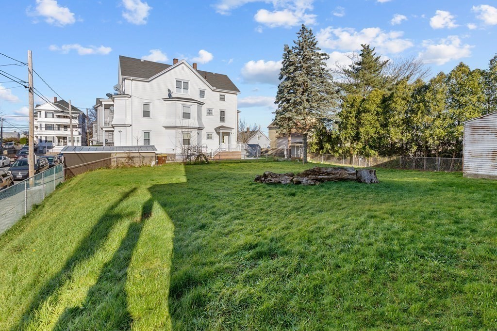 42 Mott Street Fall River, MA 02721 - Photo 3 of 36 a view of a big house with a big yard and large trees