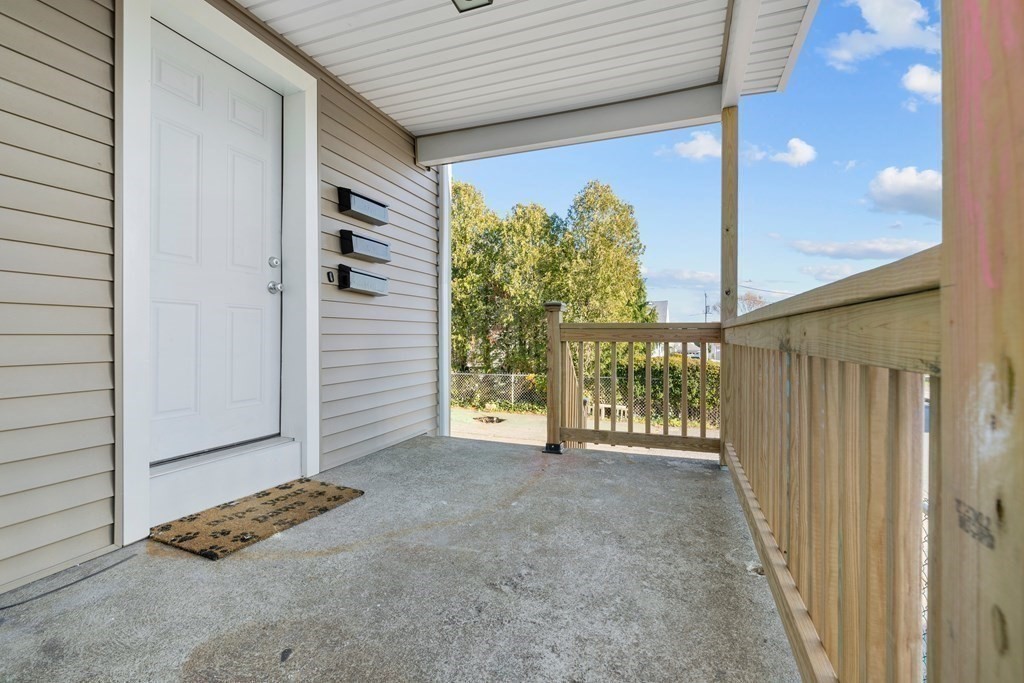 42 Mott Street Fall River, MA 02721 - Photo 34 of 36 a view of a porch with a door and wooden floor