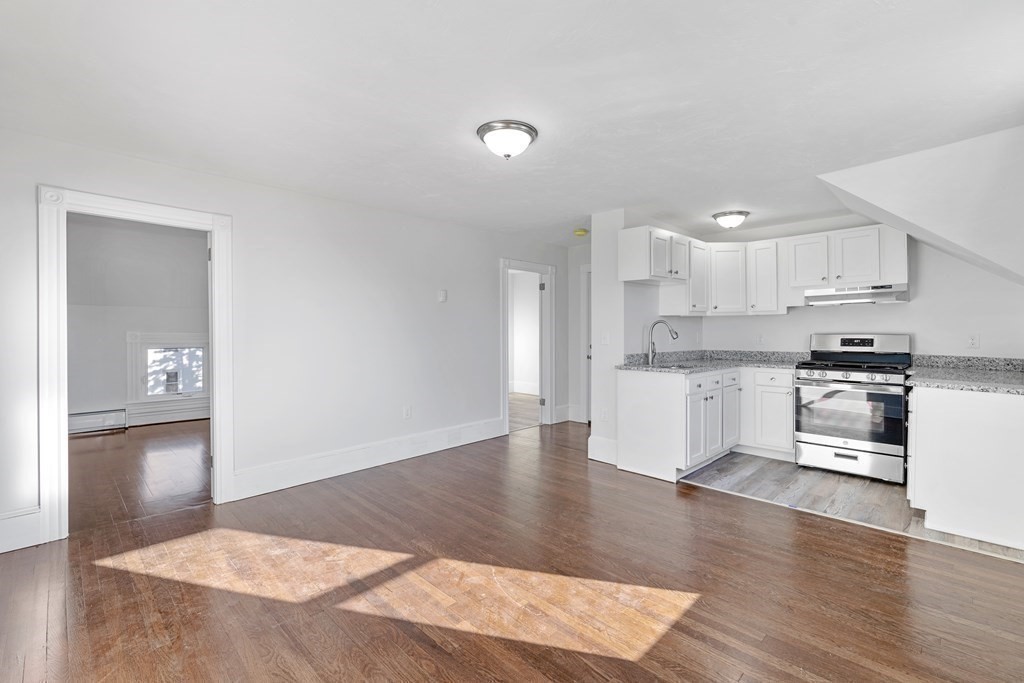 42 Mott Street Fall River, MA 02721 - Photo 8 of 36 a kitchen with stainless steel appliances kitchen island sink refrigerator and cabinets