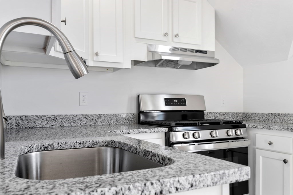 42 Mott Street Fall River, MA 02721 - Photo 9 of 36 a kitchen with stainless steel appliances granite countertop a sink a stove and cabinets