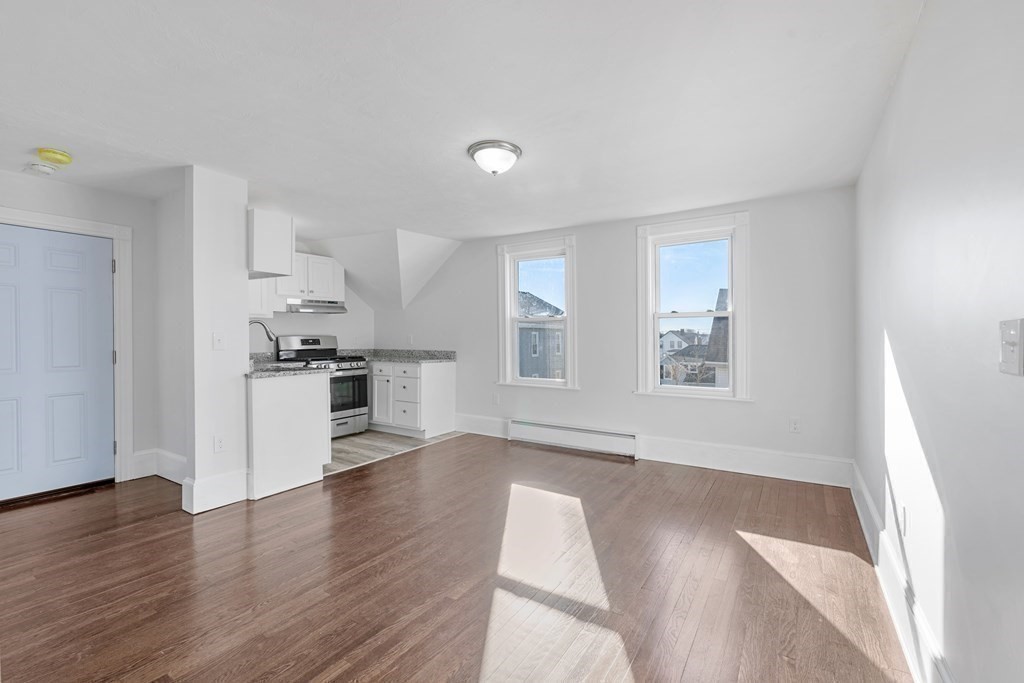 42 Mott Street Fall River, MA 02721 - Photo 10 of 36 a view of empty room with wooden floor and kitchen