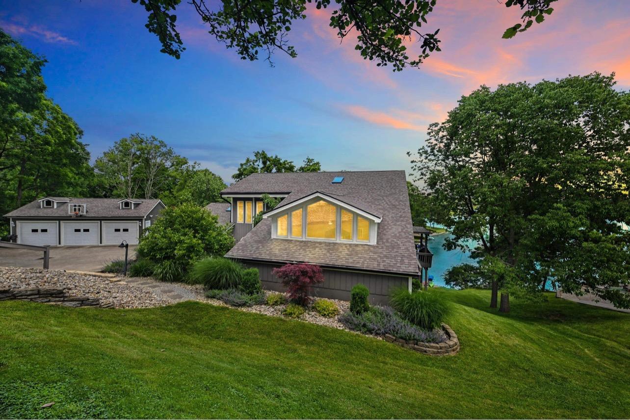 1236 Monteray Circle Lawrenceburg, IN 47025 - Photo 1 of 66 Welcome to your beautiful, lake front home! Large, spacious home with detached 3 car garage, that sits on 1.5 lots (over half acre) with ~150' of water frontage, easy walk to the dock with boat lift, great swimming, and your very own private, sandy beach! Fantastic location on the lake, with views of the main lake, but the privacy of being tucked away on a cove. Short distance to Willie's, HVL Golf Course, walking trails and ball fields! Most big ticket items are newer!