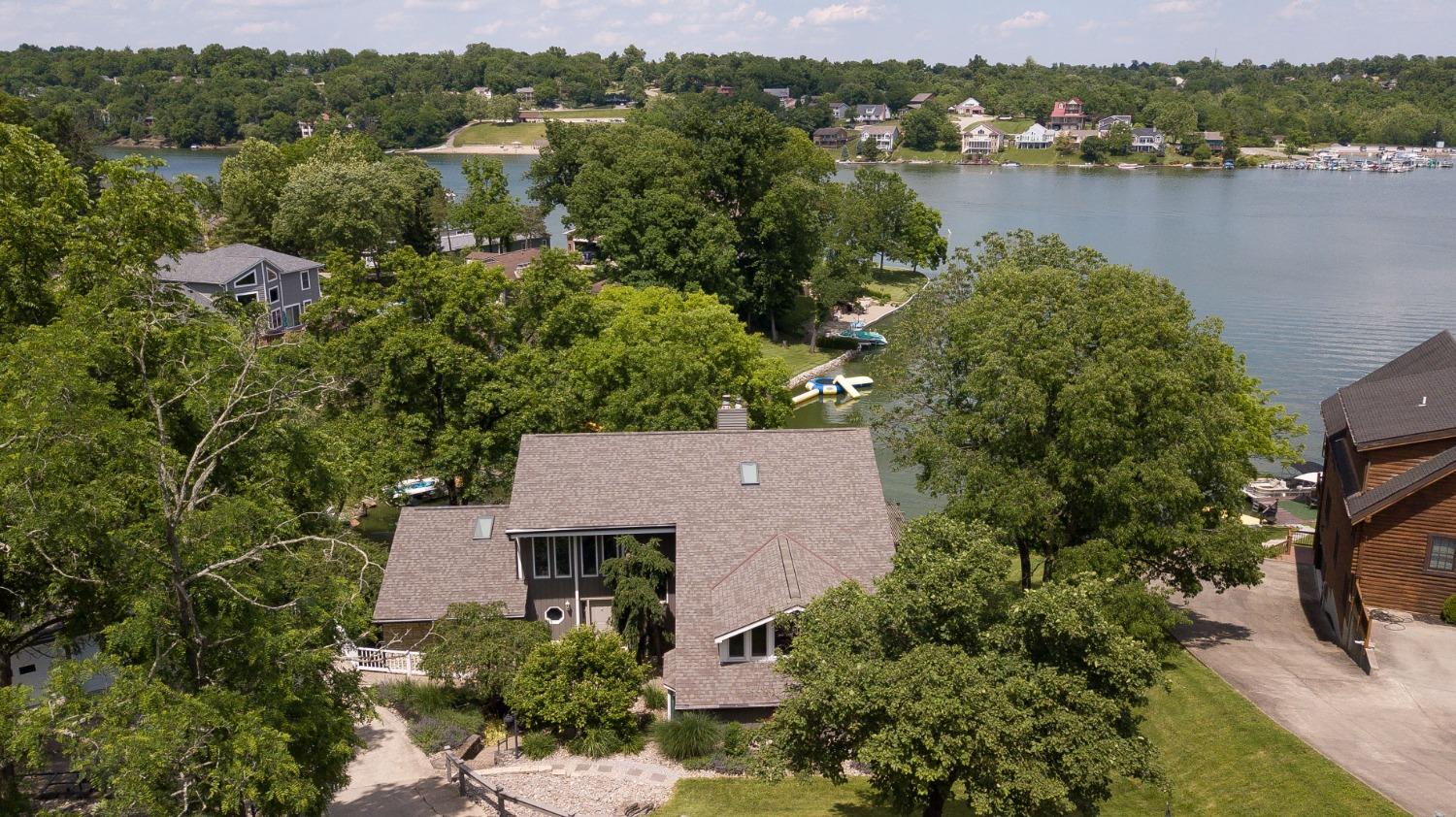 1236 Monteray Circle Lawrenceburg, IN 47025 - Photo 3 of 66 Welcome to your beautiful, lake front home! Large, spacious home with detached 3 car garage, that sits on 1.5 lots (over half acre) with ~150' of water frontage, easy walk to the dock with boat lift, great swimming, and your very own private, sandy beach! Fantastic location on the lake, with views of the main lake, but the privacy of being tucked away on a cove. Short distance to Willie's, HVL Golf Course, walking trails and ball fields! Most big ticket items are newer!