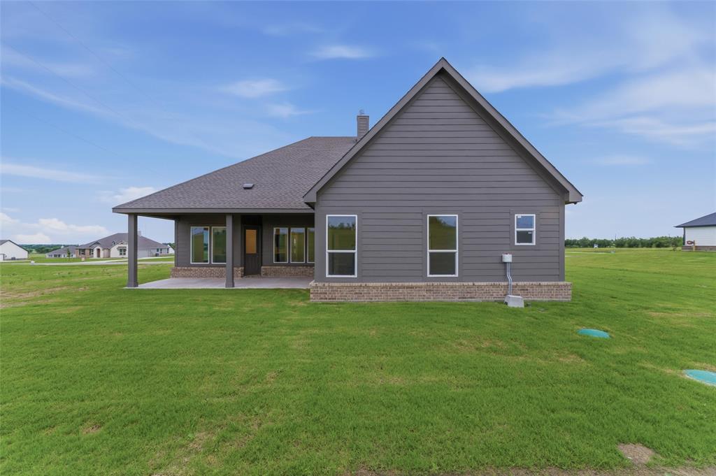 119 Hillview Trail Decatur, TX 76234 - Photo 27 of 30 Rear exterior featuring a covered patio with columns, brick skirting, gray horizontal siding, and multiple windows