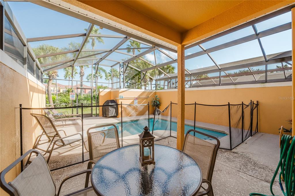8961 Majesty Palm Road Kissimmee, FL 34747 - Photo 16 of 40 a view of a chairs and table in the outdoor room