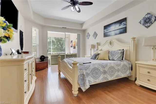 a bed room with a bed window and a flat screen tv