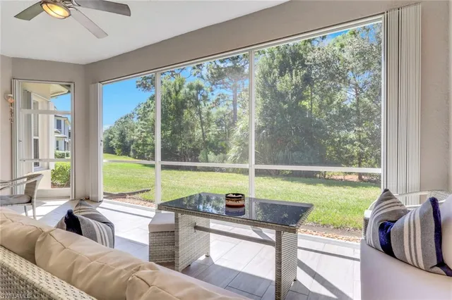 a living room with couch and a view of backyard