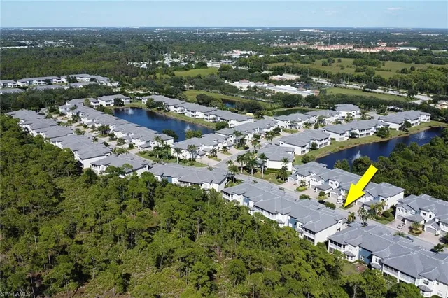 an aerial view of a houses with a swimming pool