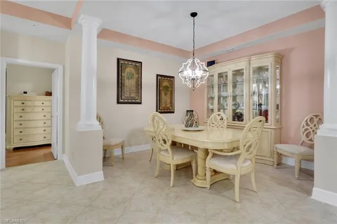 a view of a dining room with furniture and chandelier
