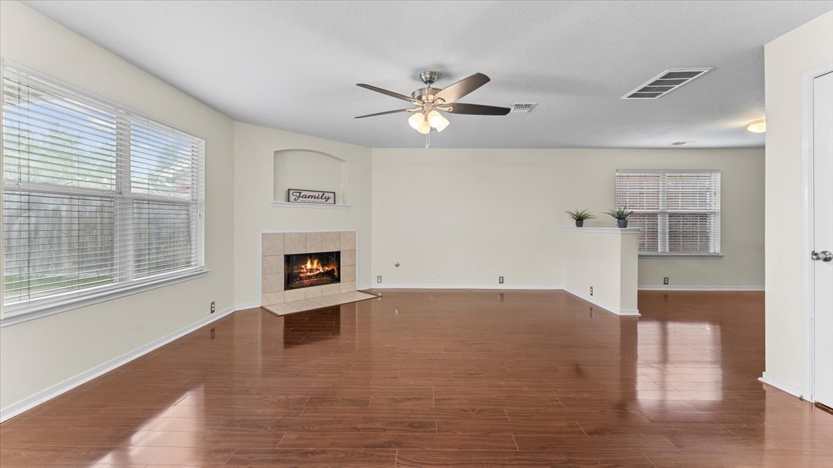 527 Cypresswood Knoll Spring, TX 77373 - Photo 17 of 45 a view of an empty room with a fireplace and a window
