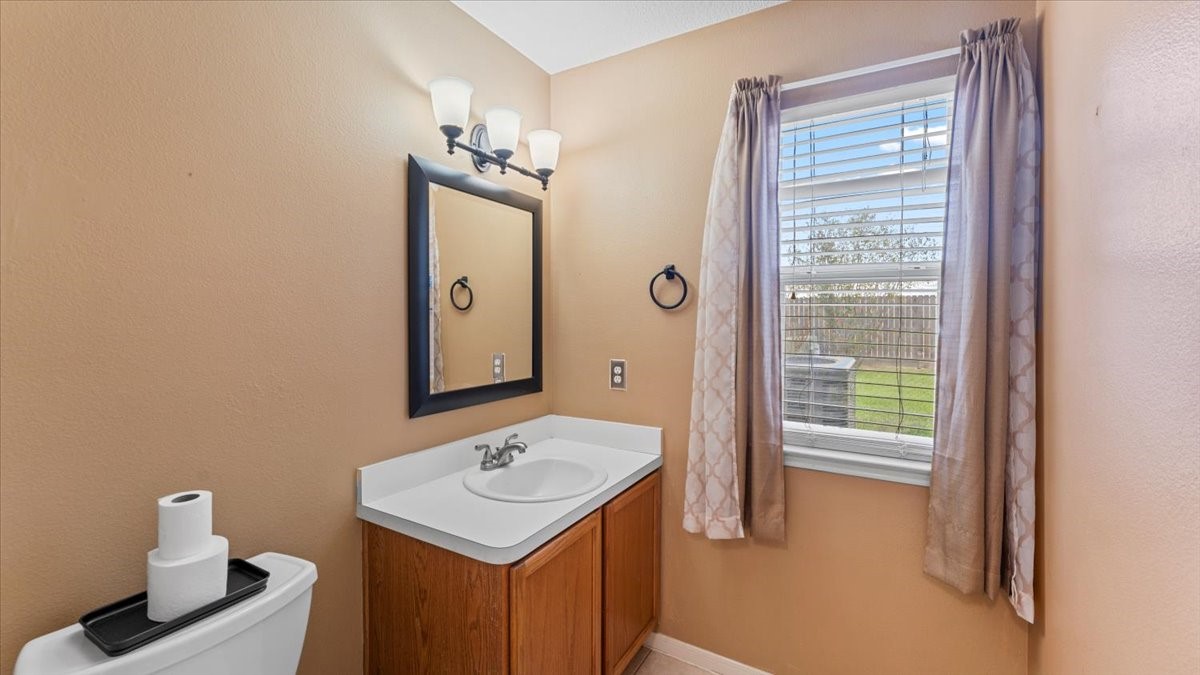 527 Cypresswood Knoll Spring, TX 77373 - Photo 34 of 45 a bathroom with a sink a light fixture and a toilet