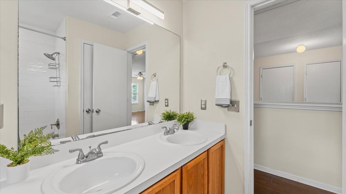 527 Cypresswood Knoll Spring, TX 77373 - Photo 40 of 45 a bathroom with a granite countertop sink a mirror and a shower