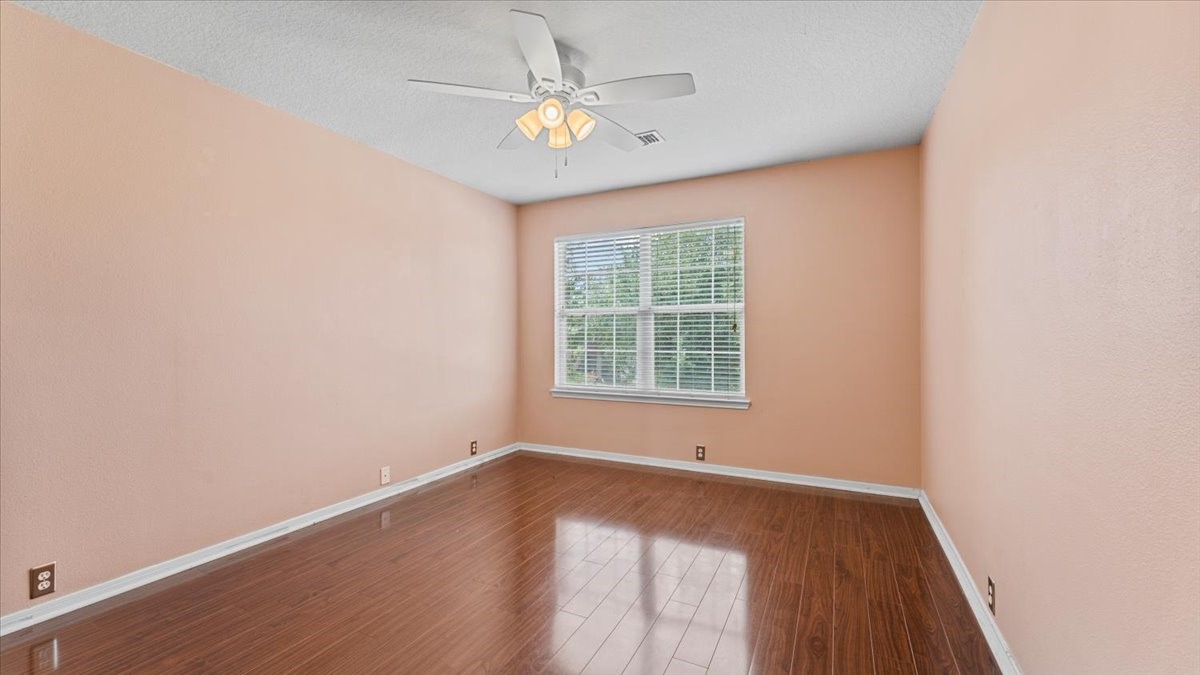 527 Cypresswood Knoll Spring, TX 77373 - Photo 41 of 45 an empty room with wooden floor and windows