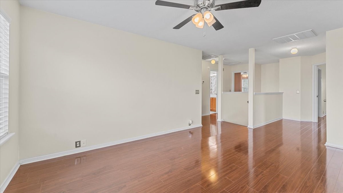 527 Cypresswood Knoll Spring, TX 77373 - Photo 42 of 45 a view of an empty room with wooden floor and a ceiling fan