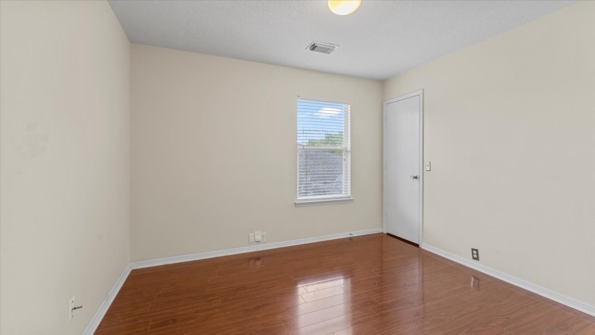 527 Cypresswood Knoll Spring, TX 77373 - Photo 43 of 45 an empty room with wooden floor and windows