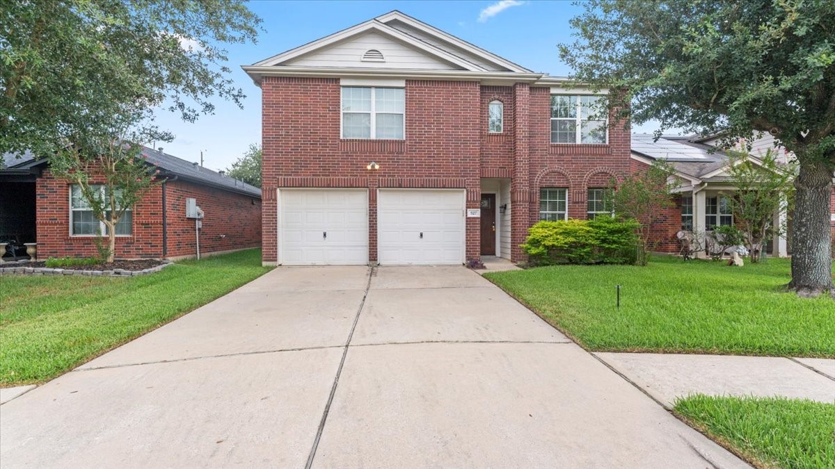 527 Cypresswood Knoll Spring, TX 77373 - Photo 10 of 45 a front view of a house with a garden and trees