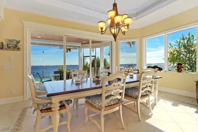 a very nice looking dining room with a large window table and chairs