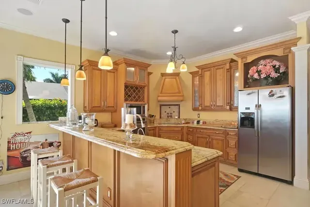 a kitchen with stainless steel appliances granite countertop a sink a stove and a refrigerator