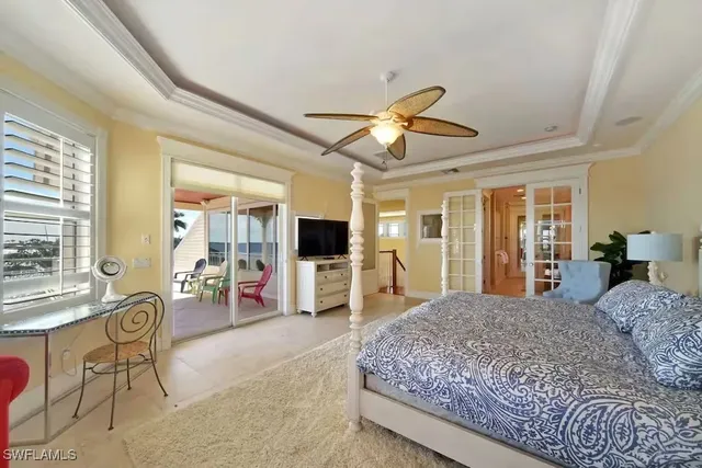 a living room with furniture a flat screen tv and a large window